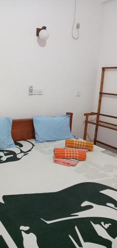 a bedroom with a bed with a blanket at Pravindi Guest Home in Mirissa