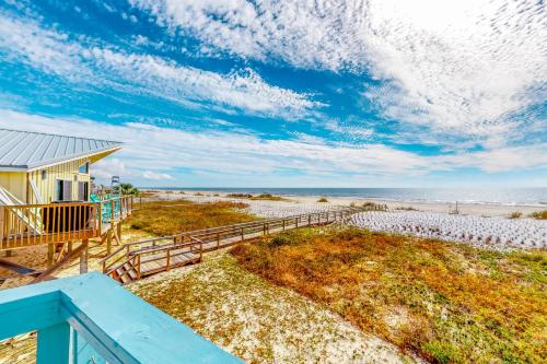 a view of the beach from the balcony of a house at A Wise Way in Indian Pass