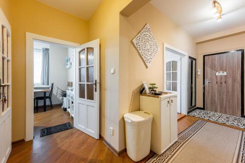 a room with yellow walls and a hallway with a door at Old Town Vintage Apartment Sturova in Košice