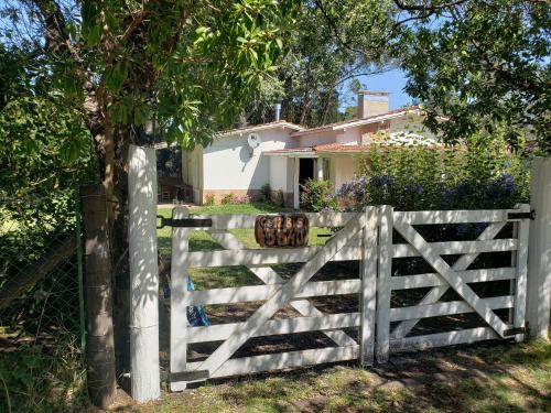 a white fence in front of a house at La Casa de Sibel in Chapadmalal