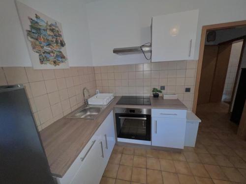 a small kitchen with a sink and a stove at HamOr Apart nähe westfield in Oberhausen