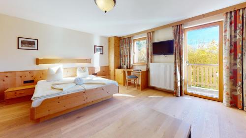 Postel nebo postele na pokoji v ubytování Hotel Daxer