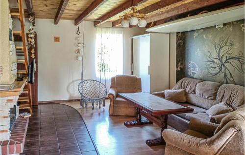 a living room with a couch and a table at 2 Bedroom Pet Friendly Home In Prabuty in Laskowice