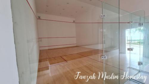 a room with a glass shower and a wooden floor at Bali Residences by Fauzah Muslim Homestay in Melaka