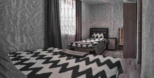 a bedroom with two beds and a window at Welcome in Dilijan