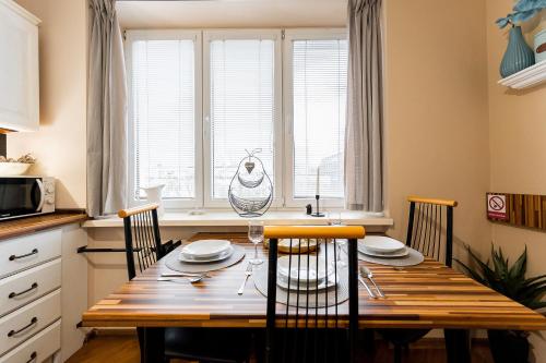 a kitchen with a wooden table and chairs in a kitchen at Old Town Vintage Apartment Sturova in Košice