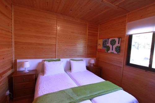 a small bedroom with a bed and a window at Parque Biologico de Vinhais in Vinhais