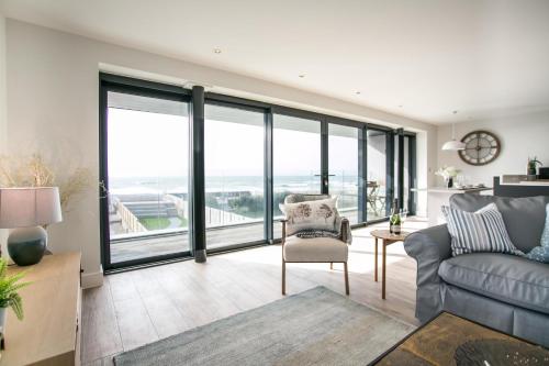 a living room with a couch and a chair at Edgewater - Bracklesham Bay in Bracklesham Bay