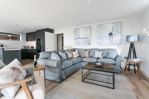a living room with a couch and a table at Edgewater - Bracklesham Bay in East Wittering