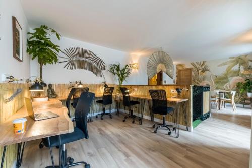 a room with wooden tables and chairs and a counter at Santo - Coworking - Coliving - Madrid in Madrid