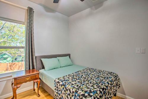 a small bedroom with a bed and a window at Denison Home with Balcony Walk to Downtown! in Denison