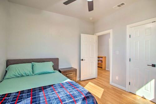 a bedroom with a bed and a ceiling fan at Denison Home with Balcony Walk to Downtown! in Denison