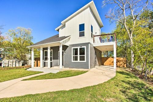 a large white house with a driveway at Denison Home with Balcony Walk to Downtown! in Denison