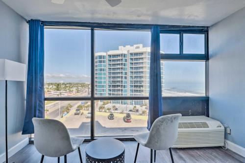 a room with a large window with a view of a building at Beachfront Daytona Studio, Close to Parks! in Daytona Beach