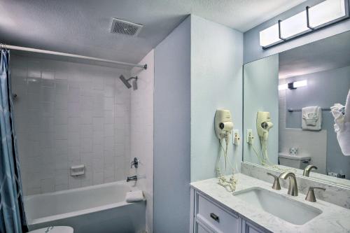 a bathroom with a tub and a sink and a mirror at Beachfront Daytona Studio, Close to Parks! in Daytona Beach