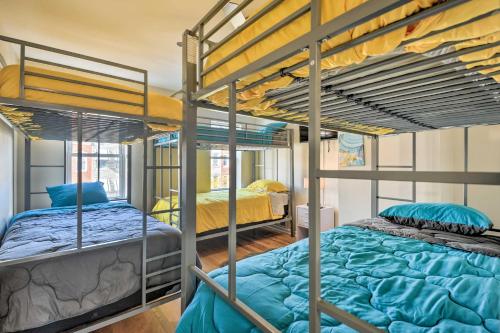 two bunk beds in a room with two beds at Baltimore Townhome Near Oriole Park with AandC! in Baltimore