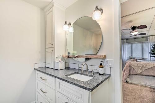 a bathroom with a sink and a mirror at Riverfront Zanesville Getaway with Private Bar! in Dresden