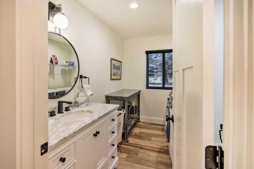 a bathroom with a sink and a mirror at Renovated Riverfront Missoula Home with Deck! in Missoula