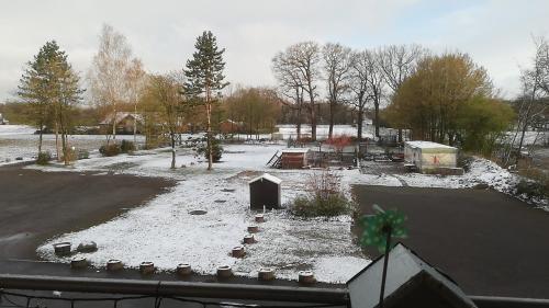 a yard with snow on the ground and a fence at Gästehaus Grunewald Bed & Breakfast in Heiden