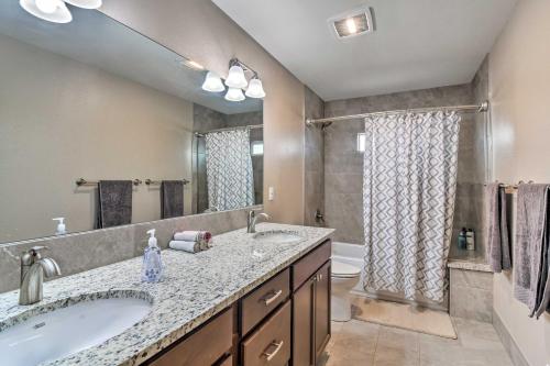 a bathroom with two sinks and a tub and a toilet at Cozy Retreat with Yard Space about 11 Mi to Longmont! in Platteville
