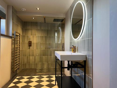 a bathroom with a sink and a mirror at The Plough in Wigglesworth