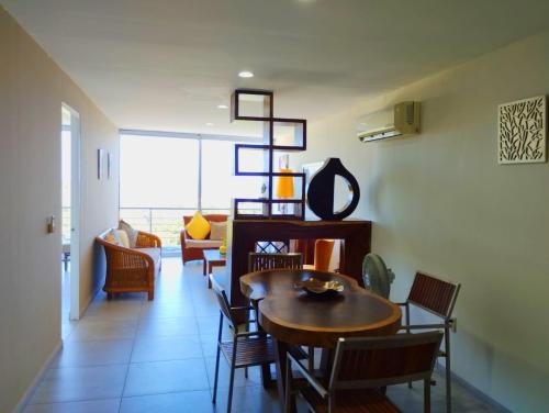 a living room with a dining room table and chairs at Playa & Piscina en Punta Gaviota in Tangolunda