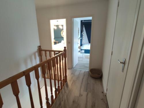 a hallway with a staircase leading to a room at Résidence Beaudelot in Saint-Saulve