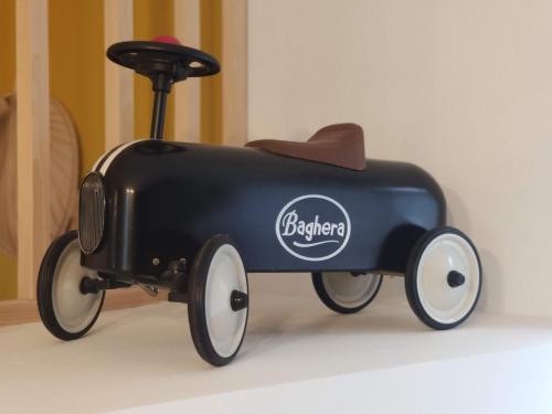 a black toy train with a cowboy hat on it at Résidence Beaudelot in Saint-Saulve