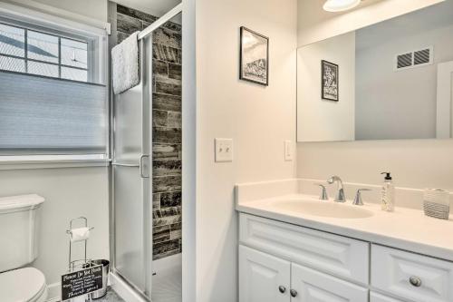 a white bathroom with a sink and a shower at Charming Farmhouse Walk to Village and Trails! in East Burke