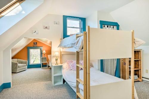 a bedroom with two bunk beds in a attic at Charming Farmhouse Walk to Village and Trails! in East Burke