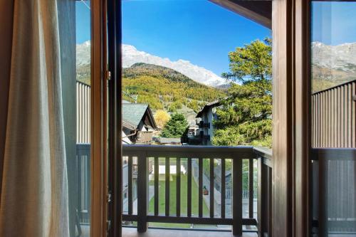 a view from a balcony with a view of mountains at Olympic Chalet 12 in Bormio