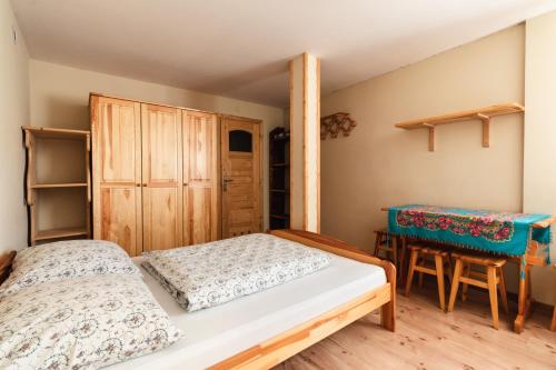 a bedroom with two beds and a table at Pokoje u Danusi in Groń