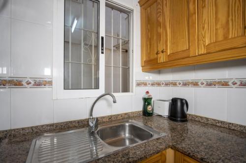 a kitchen counter with a sink and a window at Alegria ID40 in Torrevieja