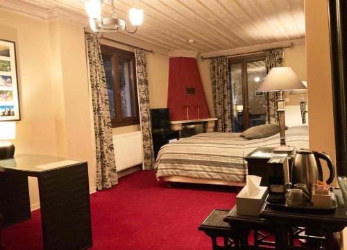 a hotel room with a bed and a desk with a computer at Boutique Hotel Skamnos Arachova in Arachova