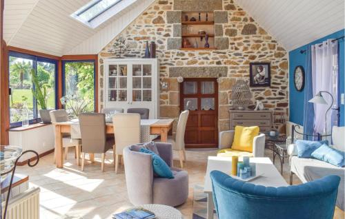 a kitchen and living room with a stone wall at Awesome Home In Trézélanbégard in Trézelan