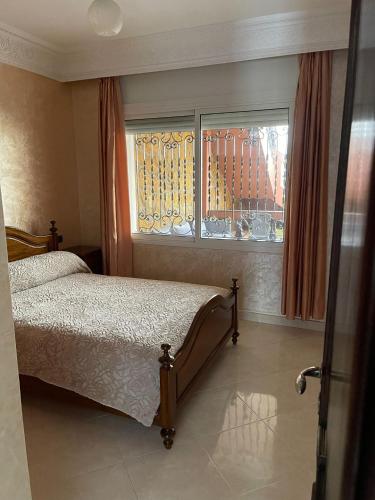 a bedroom with a bed and a window at Villa a tamaris dar bouazza in Casablanca