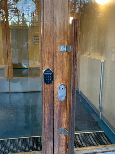 a wooden door with a lock on it at 2BR Apartment, free parking - Peikontie in Oulu