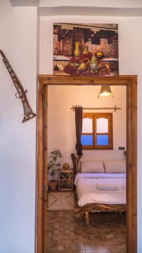 a bedroom with a bed with a wooden frame at WaveGo Surf Camp in Imsouane
