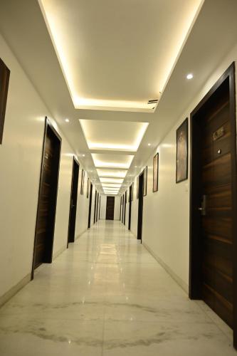 a hallway in a building with a long corridor at Hotel Lawrence in Amritsar