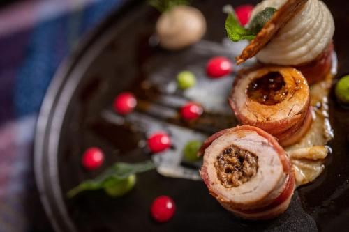 a plate with three pastries on top at No11 Boutique Hotel & Brasserie in Edinburgh