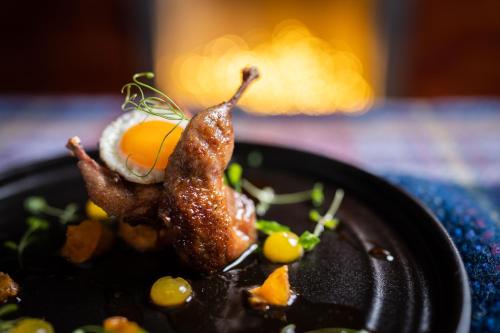 a plate of food with a fried egg on top at No11 Boutique Hotel & Brasserie in Edinburgh