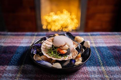 a bowl of food sitting on a table at No11 Boutique Hotel & Brasserie in Edinburgh