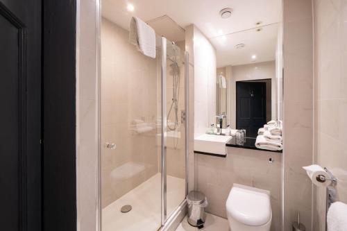 a bathroom with a shower and a toilet and a sink at No11 Boutique Hotel & Brasserie in Edinburgh