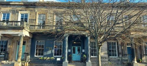 a blue house with a tree in front of it at No11 Boutique Hotel & Brasserie in Edinburgh