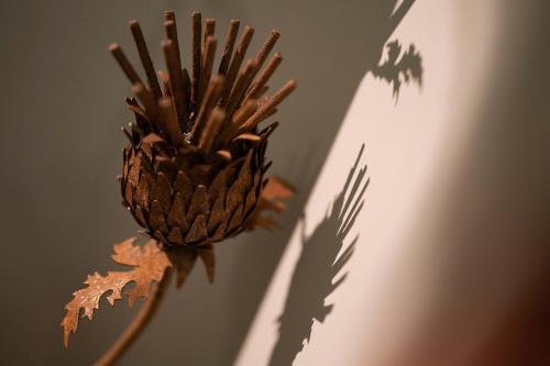 a pineapple is sitting on a wall with its shadow at No11 Boutique Hotel & Brasserie in Edinburgh