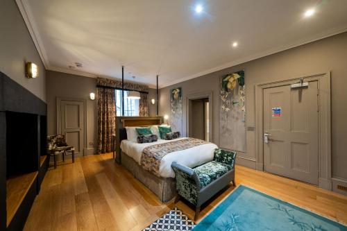 a hotel room with a bed and a tv at No11 Boutique Hotel & Brasserie in Edinburgh