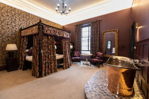 a large room with a bed and a mirror at No11 Boutique Hotel & Brasserie in Edinburgh