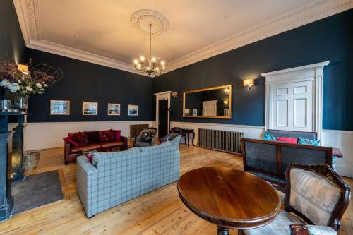 a living room with a couch and a table at No11 Boutique Hotel & Brasserie in Edinburgh