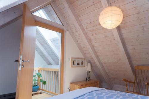 a bedroom with a bed and a large window at Ferienwohnung Spessart in Straßbessenbach