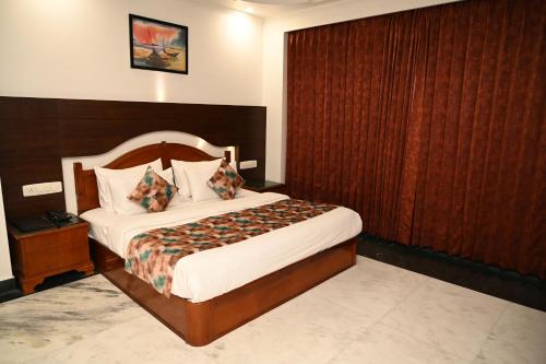 a bedroom with a bed with a wooden wall at Hotel Lawrence in Amritsar